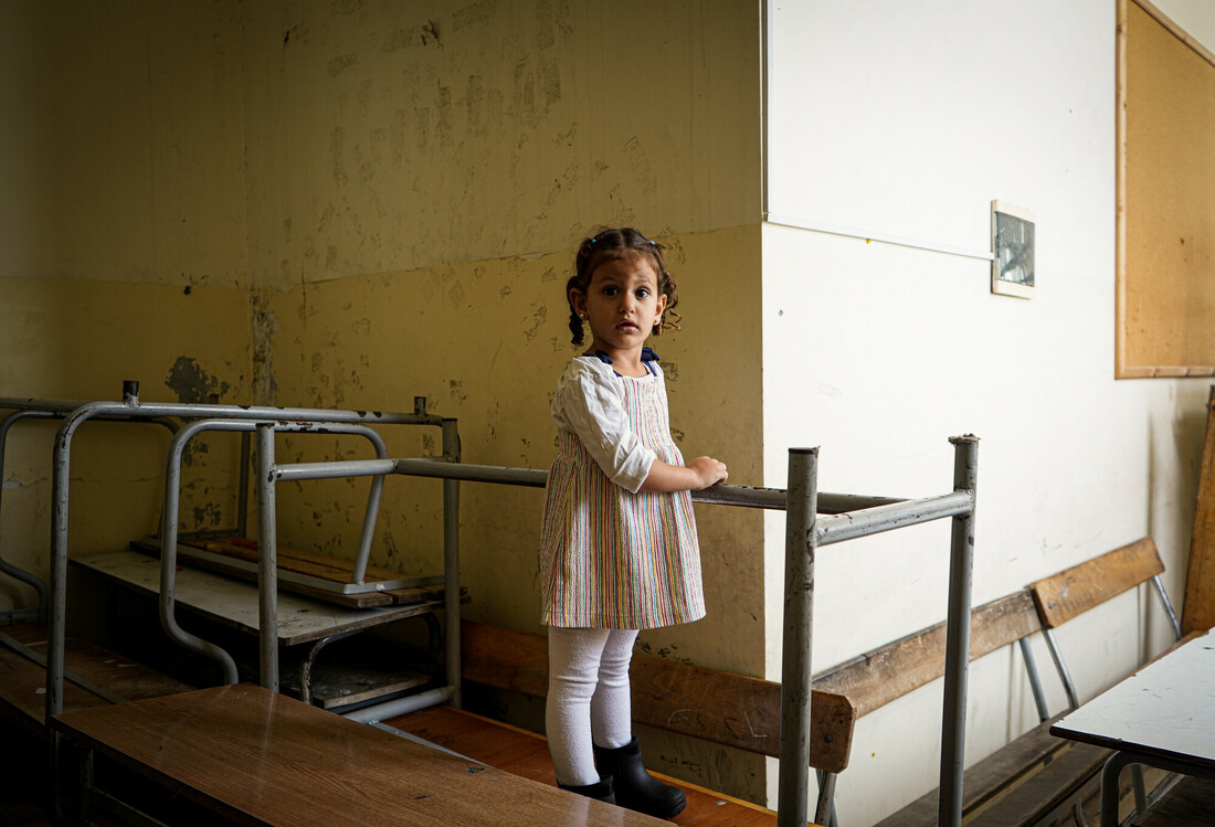Girl playing on abandonded school furniture